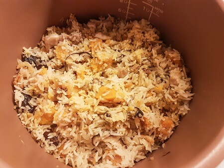 Cooked pumpkin rice in a rice cooker